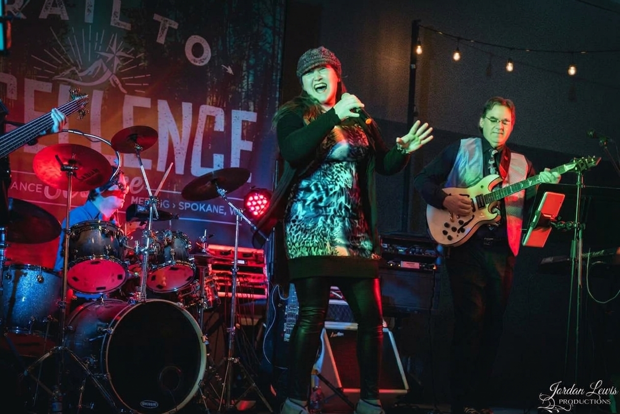 Bridgette singing with Michael on guitar at a live show