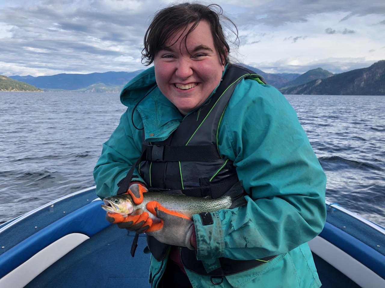 Bridgette holding a fish on the water