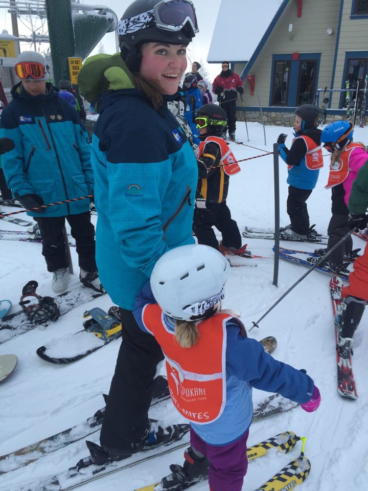 Bridgette helping a young skier